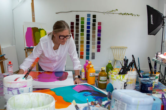 Abstract artist Claire Desjardins, painting in her art studio.