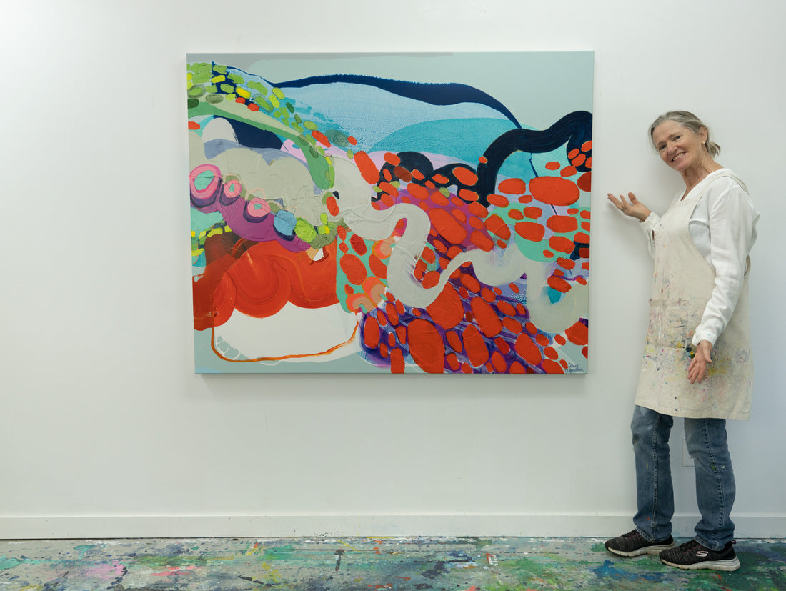 Abstract artist Claire Desjardins, next to her painting.