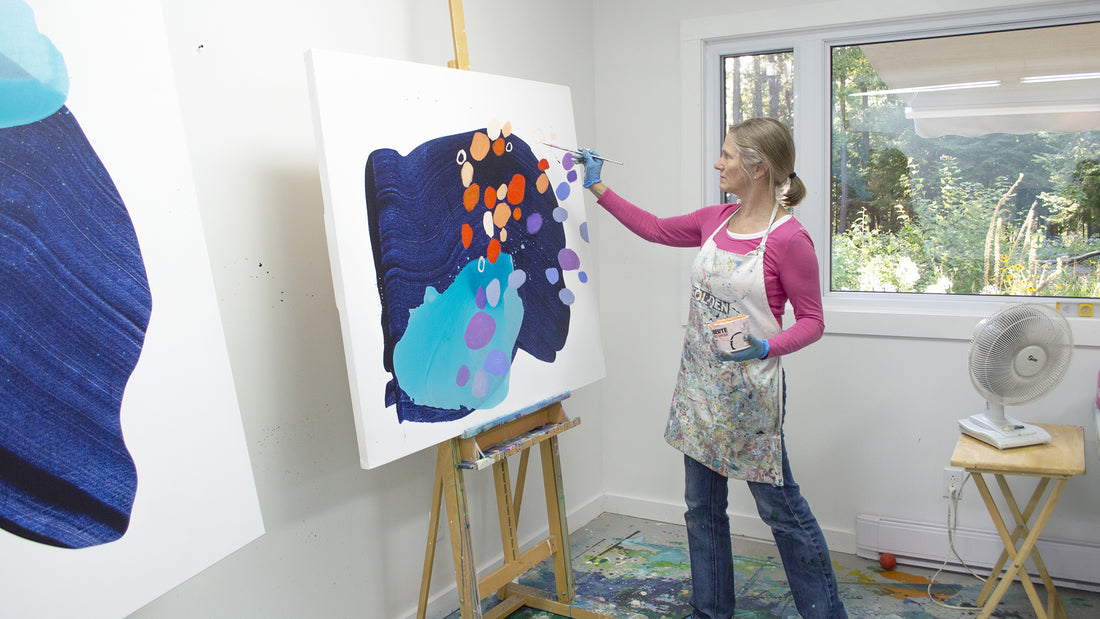 Abstract artist, Claire Desjardins, painting in her studio.