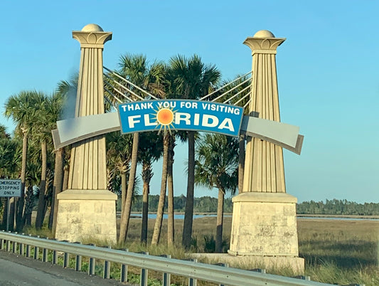 Departing from the state of Florida by road: highway sign reads, "Thank you for visiting Florida".