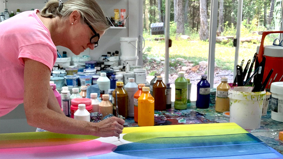 Abstract artist painter, Claire Desjardins, painting in her art studio.