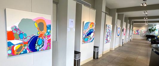 Abstract paintings of artist Claire Desjardins, hang in art gallery.