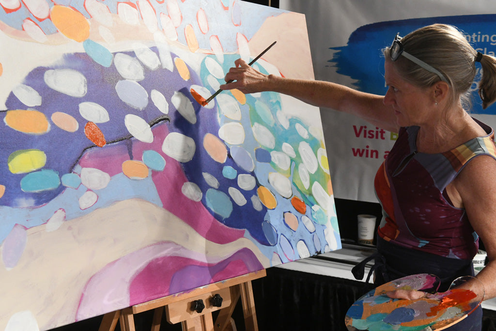 Artist Claire Desjardins, live painting abstract art on the easel.