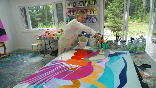 Abstract artist, Claire Desjardins, painting colors in her art studio using acrylic paints.