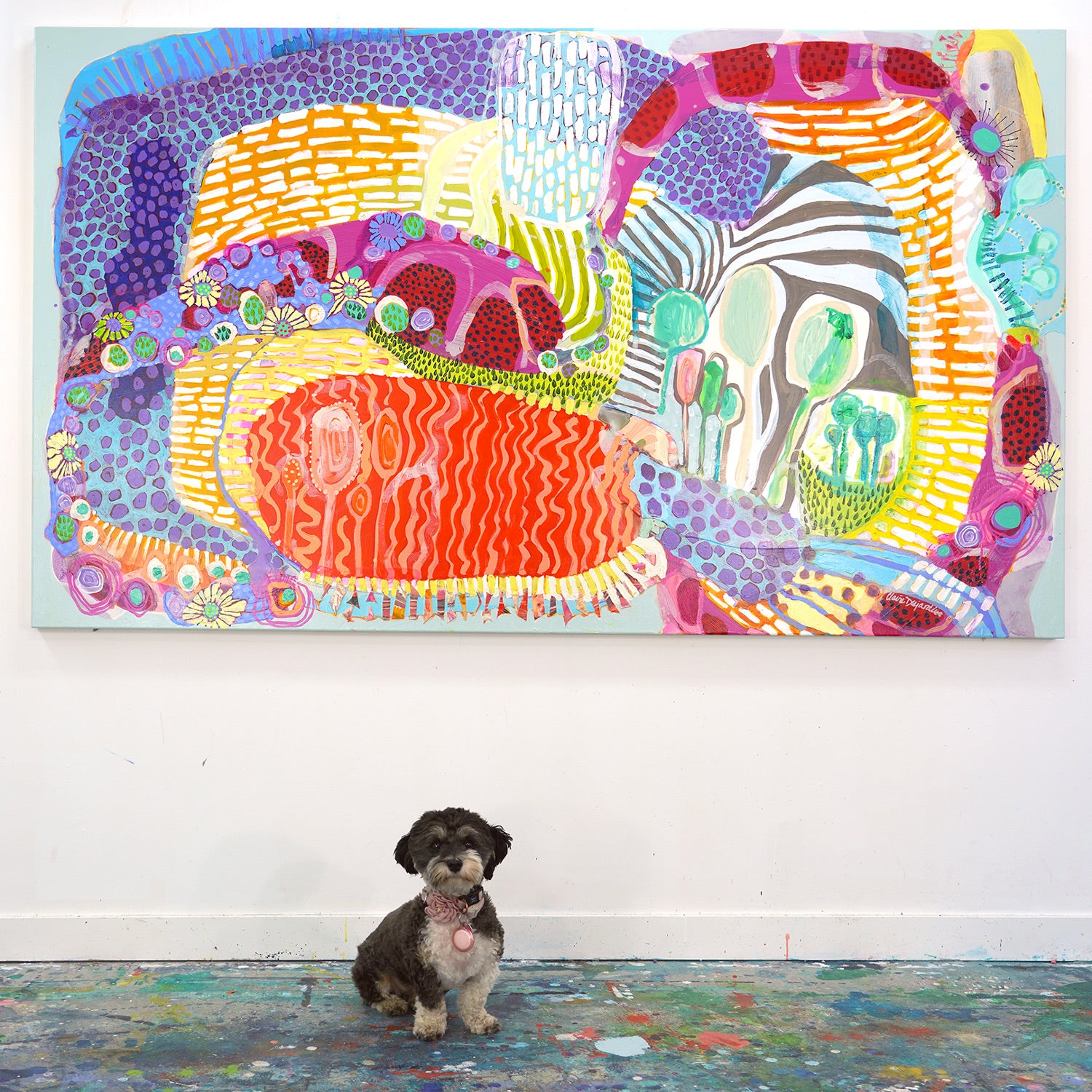 Abstract collage painting, "Morning Hike", by artist/painter Claire Desjardins. Her little black and white dog sits in front of the painting.